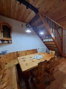 a wooden table and chairs in a room at Baita degli Alpini in Terminillo