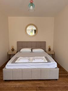 a large bed in a bedroom with a mirror at Pollux Astra Bay in Lepetani