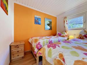 a bedroom with two beds and a dresser and two windows at Apartment Gabi-1 by Interhome in Wiek auf Rügen