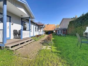 a house with a porch and a yard with a bench at Apartment Gabi-1 by Interhome in Wiek auf Rügen