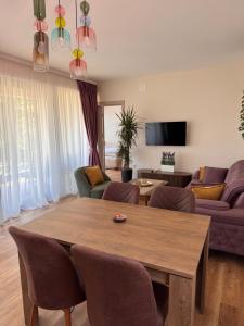 a living room with a table and a couch at Pollux Astra Bay in Lepetani