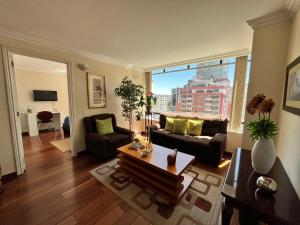 a living room with a couch and a table at BlueZone Apartments in Quito