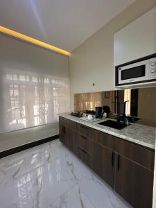 a kitchen with a counter top and a microwave at Centurion Aparthotel in Abuja