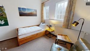 a small room with a bed and a window at Reiterpension Marlie in Scharbeutz