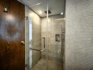 a shower with a glass door in a bathroom at Hotel Windy Terrace in Cox's Bazar