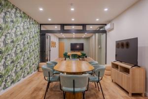 a conference room with a table and chairs and a tv at Dorisol Buganvilia Studio Hotel in Funchal