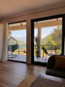 a living room with sliding glass doors with a view at Pollux Astra Bay in Lepetani