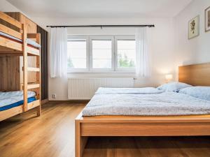 a bedroom with a bed and a bunk bed at Chalet Golden View by Interhome in Janske Lazne