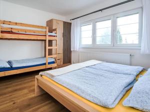 a bedroom with two bunk beds and two windows at Chalet Golden View by Interhome in Janske Lazne +37 photos