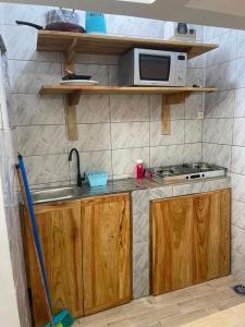 a kitchen with a sink and a microwave at Smart Residences Apart Go in Cotonou +166 photos