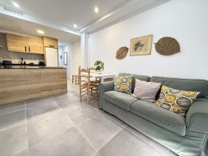 a living room with a couch and a table at Luxury beach penthouse with Jacuzzi in Fuengirola