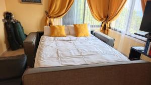 a bed with yellow pillows in a bedroom at Tango Andaluz - Sunset Ritual Incl in Fuengirola