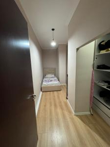 a small bedroom with a bed and a closet at Apartament Yzberish in Tirane