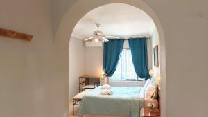 a bedroom with a bed and a ceiling fan at Tango Andaluz - Sunset Ritual Incl in Fuengirola
