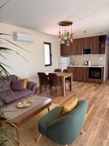 a living room with a couch and a table at Pollux Astra Bay in Lepetani
