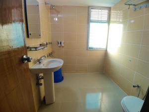 a bathroom with a sink and a mirror at Cox West Inn in Cox's Bazar