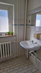 a bathroom with a sink and a window at Gästehaus Wilsickow in Lübbenow +59 photos