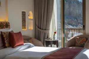 a hotel room with a bed and a balcony at Sost Serena Hotel in Gircha +45 photos