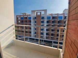 a balcony with a view of a building at Cox West Inn in Cox's Bazar