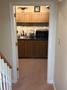 a kitchen with a sink and a microwave at Wasaga Dunes in Wasaga Beach +11 photos