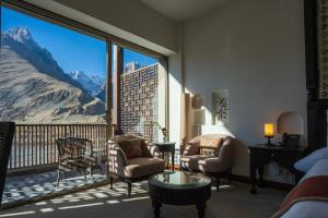 a living room with a large window with a mountain view at Sost Serena Hotel in Gircha