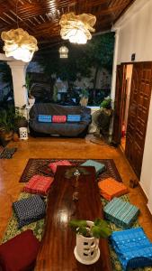 a room with a table and pillows on the floor at MI CASA Luang Prabang in Luang Prabang
