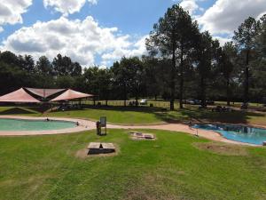 a park with a tent and a swimming pool at The View on Vaal Resort in Sasolburg
