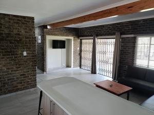 a living room with a couch and brick walls at The View on Vaal Resort in Sasolburg