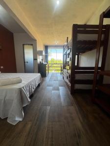 a bedroom with two bunk beds and a hallway at Recanto Praia do Sargi in Uruçuca