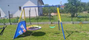 a playground with swings in a yard at Chatka u Goni Camp przy SUNTAGO in Grabce