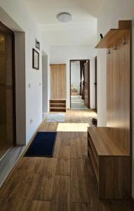 a living room with wooden floors and a hallway at Душковата къща in Chekhlare