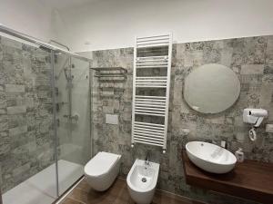 a bathroom with a sink and a toilet and a mirror at B&B La Casa Nel Borgo in Morano Calabro +17 photos