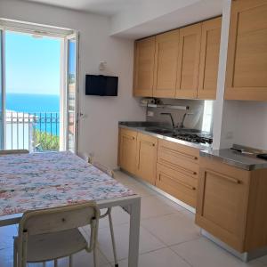 a kitchen with a table and a view of the ocean at Il Faro, Sirolo centro Vista Mare in Sirolo