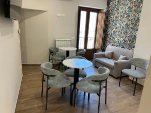 a living room with a couch and tables and chairs at B&B La Casa Nel Borgo in Morano Calabro