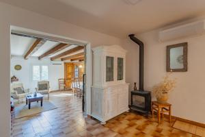 a living room with a fireplace and a stove at "Chez Jean" à Ruoms in Ruoms