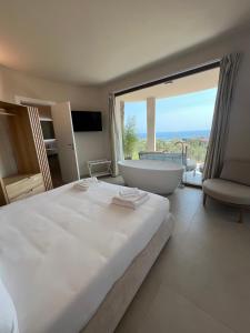 a bedroom with a large bed with a tub and a window at Leonardo Resort in Imperia