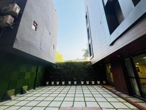 a view of a courtyard of a building at Hotel Grand Plaza - Gate No 3 Dlf Chattarpur Farms in New Delhi