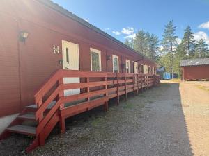 a row of benches on the side of a red building at Rena Hostel in Rena