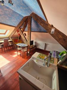 a kitchen with a sink and a roof at L'Irisée in Liévin