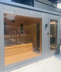 a building with a large window with a bench in it at Apartament LuLu in Gryfice
