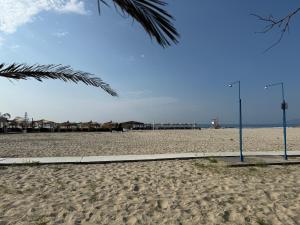 a sandy beach with two street lights on it at Villa Maria in Mángana