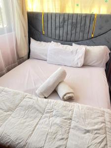 a white bed with a towel on top of it at Casa Bnb kisumu in Kisumu