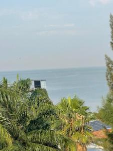 a view of the ocean from a resort with palm trees at Casa Bnb kisumu in Kisumu