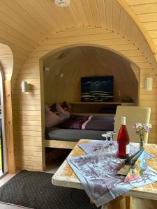 a small room with a table with a bottle of wine at Igluhuts Passail in Passail