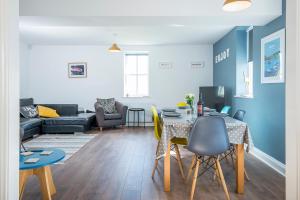 a living room with a table and a couch at Ramsey View in Solva +31 photos