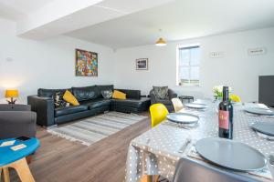 a living room with a couch and a table at Ramsey View in Solva