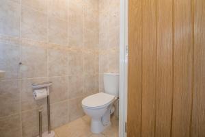 a bathroom with a white toilet in a room at Ramsey View in Solva