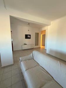 a living room with a couch in the middle at Mirina View Apartment #2 in Myrina