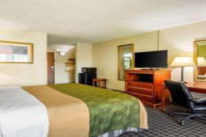 a hotel room with a bed and a flat screen tv at Hermitage Hotel Richmond Virginia in Richmond