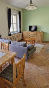 a living room with a couch and a table at Gästehaus Wilsickow in Lübbenow